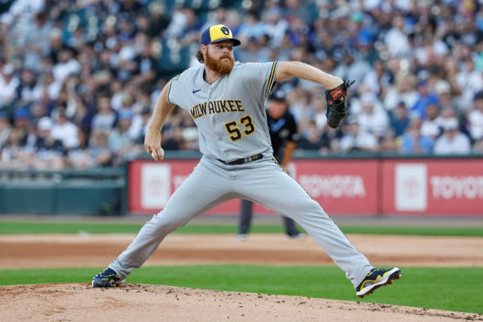 Brandon Woodruff brings his arm back holding the baseball to pitch